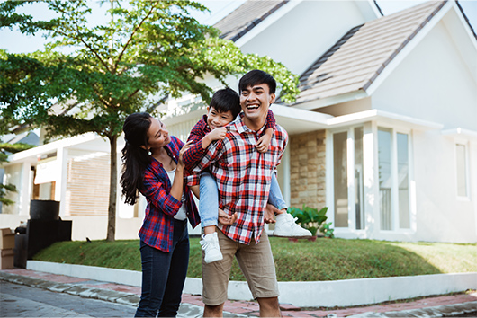 Family standing in front of home