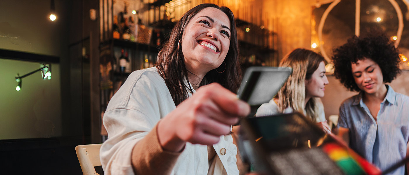 Woman paying with her APGFCU Visa Platinum Preferred Credit Card