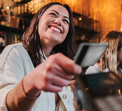 Woman paying with her APGFCU Visa Platinum Preferred Credit Card
