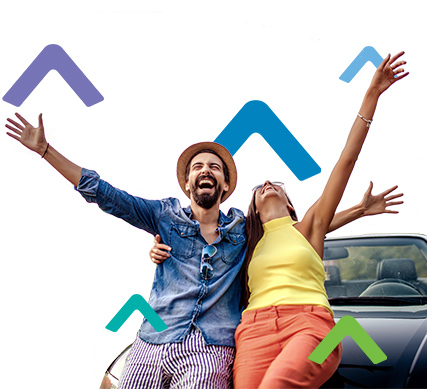smiling couple sitting on car